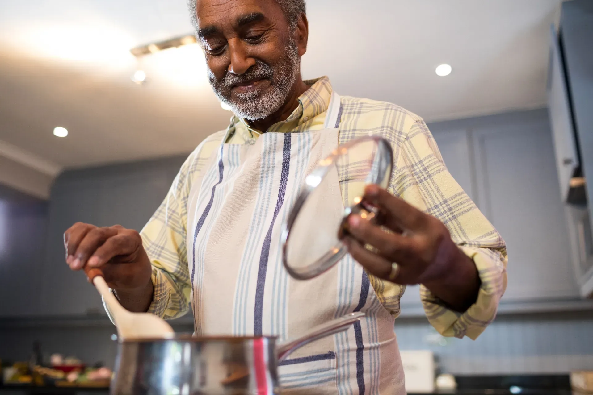 Senior man cooking in kitchen